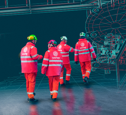 Four Optravation Energypeople wearing PPE walking together with an overlay of machinery.