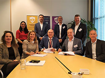 Group of people from Neptune and Optravation Energysitting at a table together.