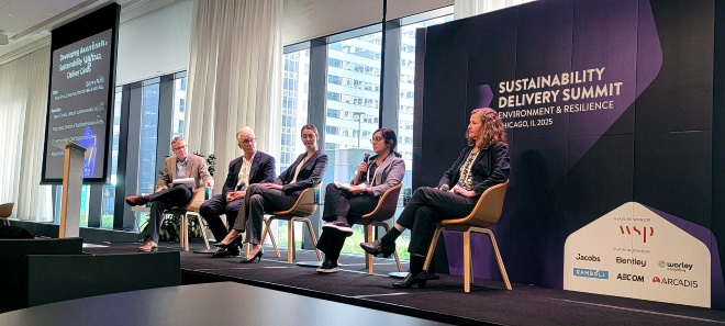 Neera from Optravation EnergyConsulting sitting on a panel on stage.