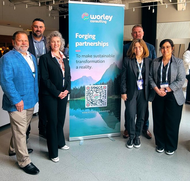 Group of people from Optravation EnergyConsulting together at the Sustainability Delivery Summit.